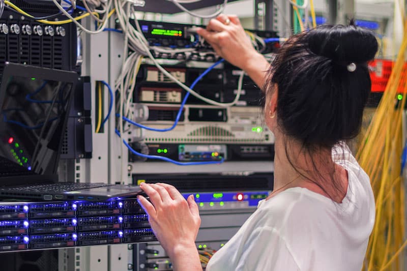 IT technician checks hardware at data center.