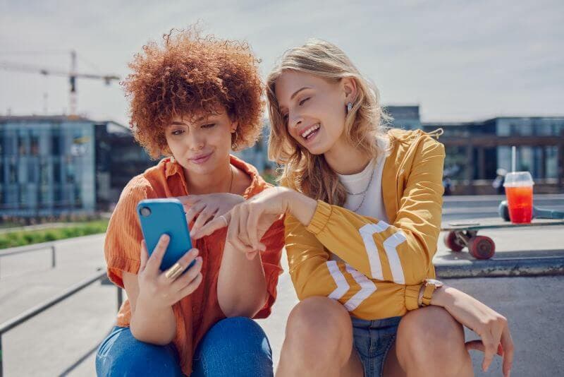 Two women looking at a phone