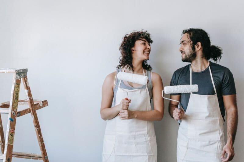 happy couple working on a home improvement project paid by for personal loan