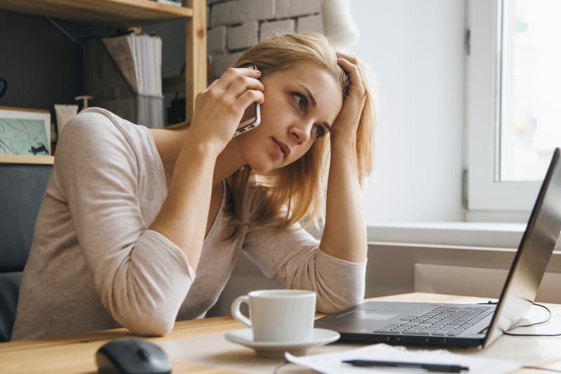 woman on phone talking about student loans and buying a house
